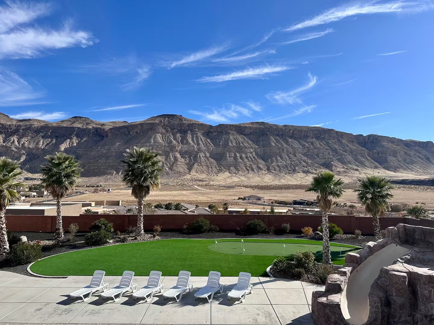 Mountain backdrop and putting green at the group house