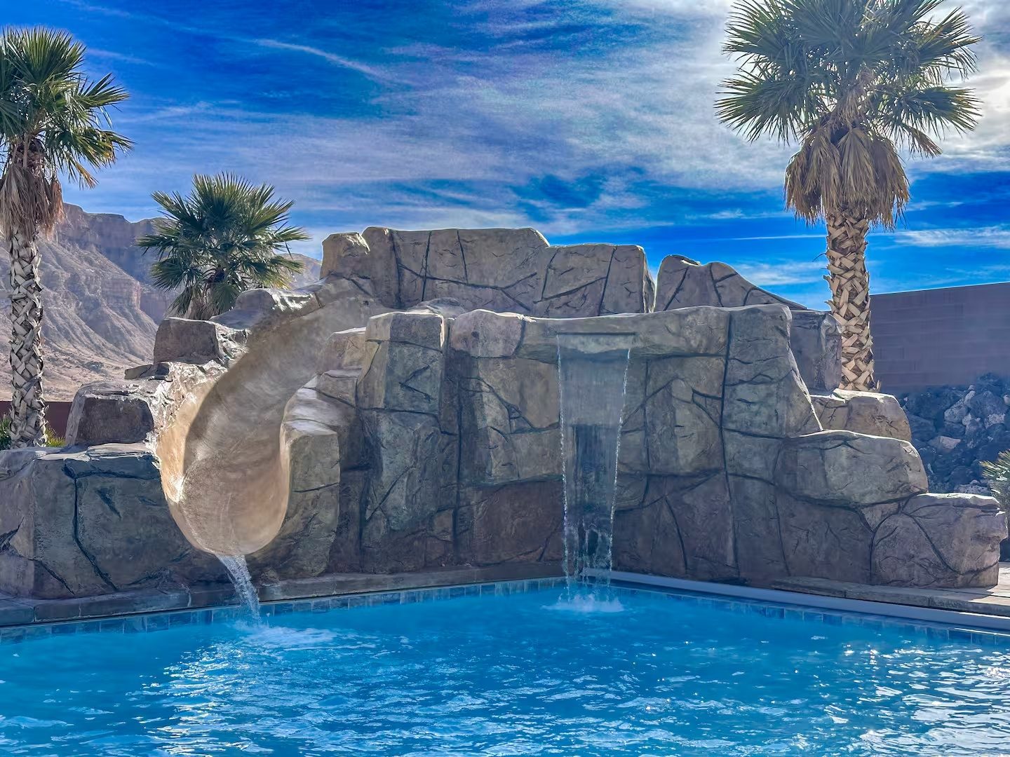 The private pool with slide and waterfall